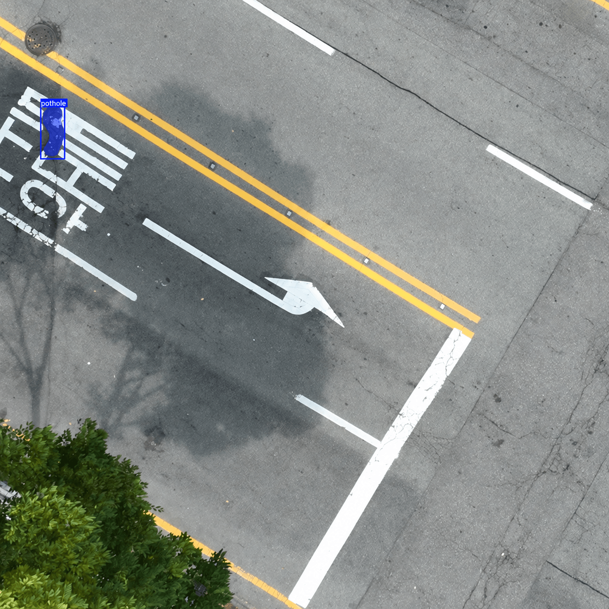 Actual pothole detection example with a blue mask and bounding box